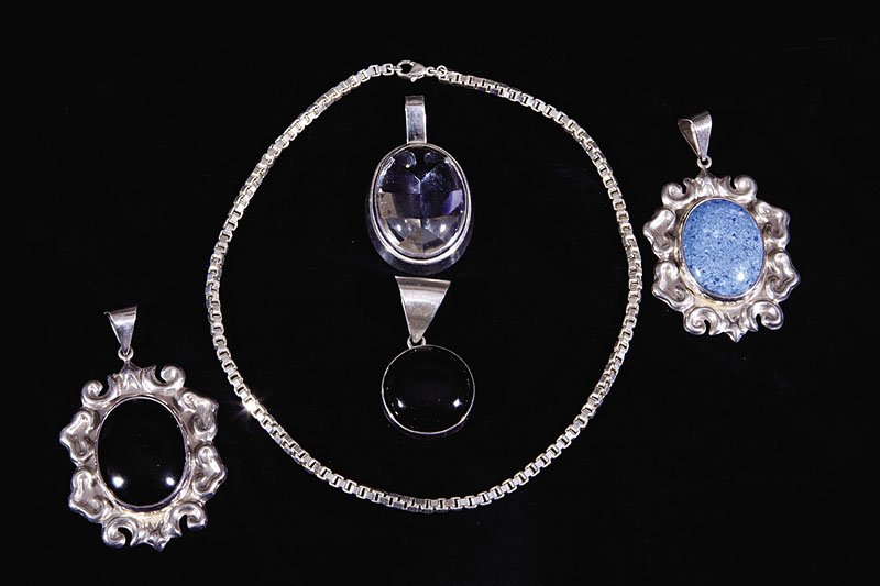 Four Mexican Sterling Silver and Stone Pendats: A Group of Four Mexican Sterling Silver and Stone Pendants with Chain, including onyx and blue agate cabochons in baroque mounts, rock crystal and onyx in plain mounts and a box link chain, chain leng
