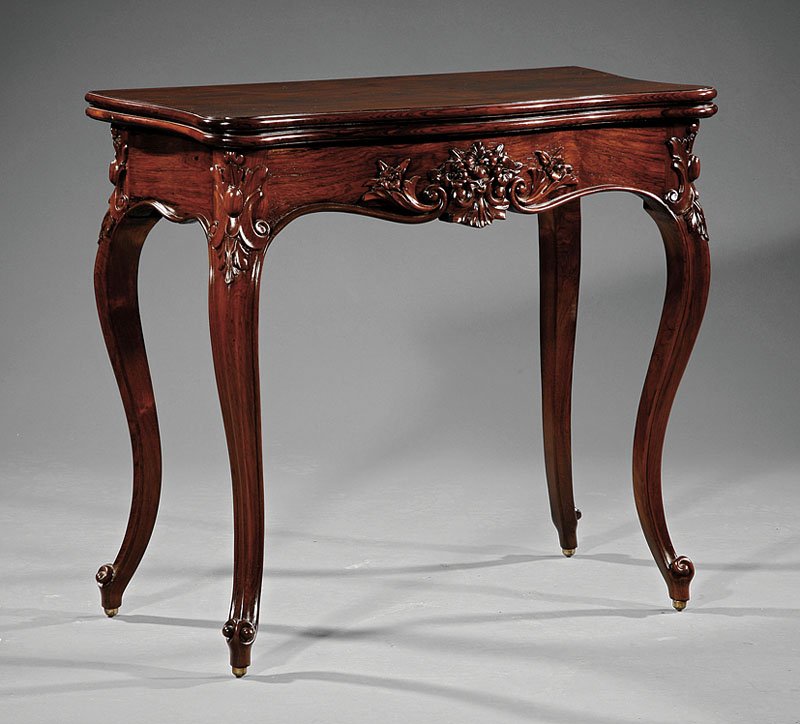 American Rococo Carved Rosewood Games Table: An American Rococo Carved Rosewood Games Table, mid-19th c., New York, serpentine foldover top, conforming floral frieze, cabriole legs, scroll feet, height 30 3/4 in., width 32 1/2 in., depth 16 in