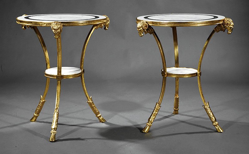 Pair of Louis XVI-Style Gilt Bronze Gueridons: A Pair of Louis XVI-Style Gilt Bronze Gueridons, each with marble top, ram's head monopodia supports joined by stretcher shelf, hoof feet, height 28 1/2 in., diameter 24 1/2 in
