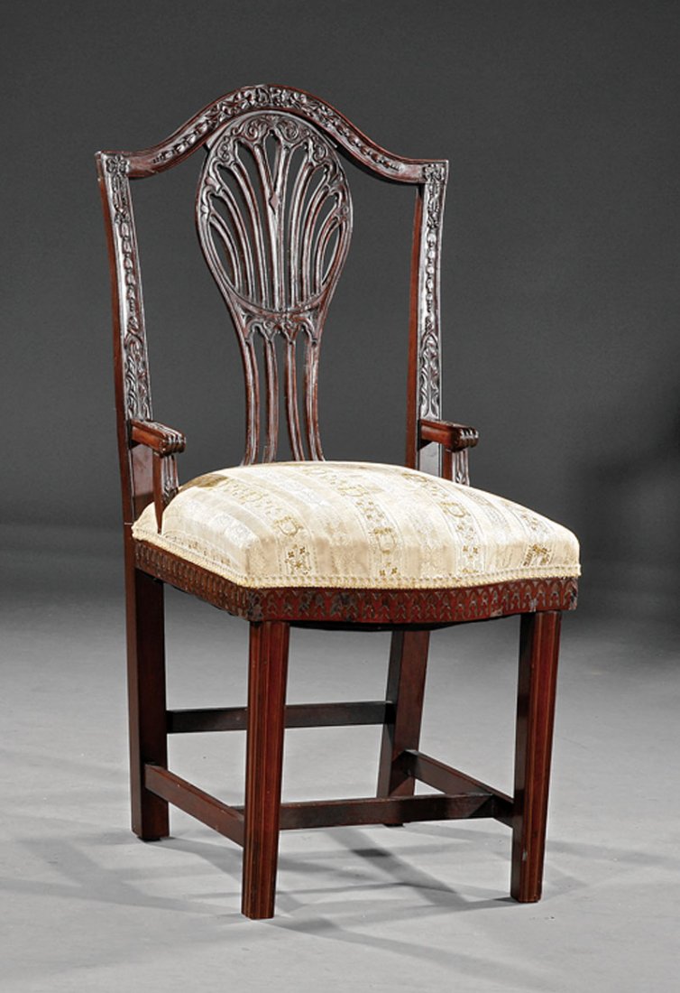 George III Carved Mahogany Nursing Chair: An Antique George III Carved Mahogany Nursing Chair in the Hepplewhite Taste, husk carved serpentine crest rail, flared stiles, pierced splat, serpentine blind fretwork seat rail, square molded legs w