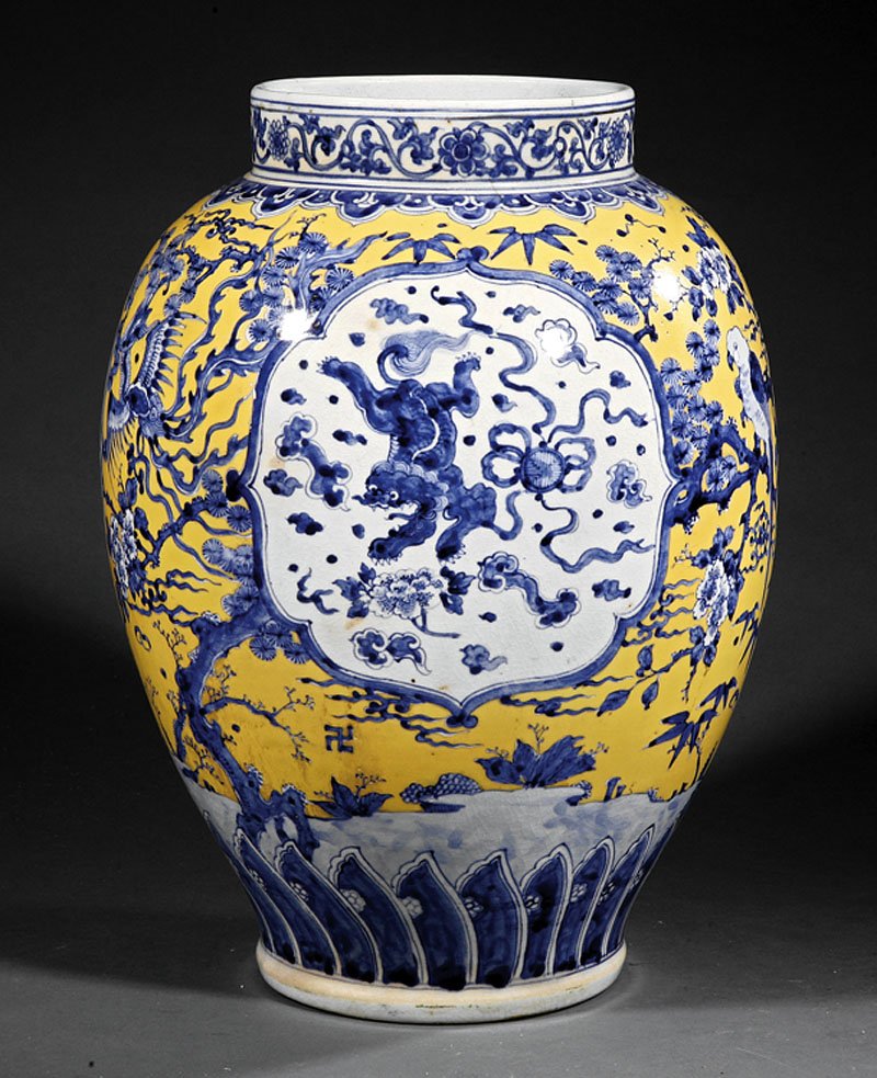 Chinese Blue and White, Yellow Porcelain Vase: A Chinese Blue and White Decorated Yellow Ground Porcelain Vase, 20th c., ovoid body decorated with Buddhist lion panels reserved on a floral ground, drilled base, height 15 1/8 in