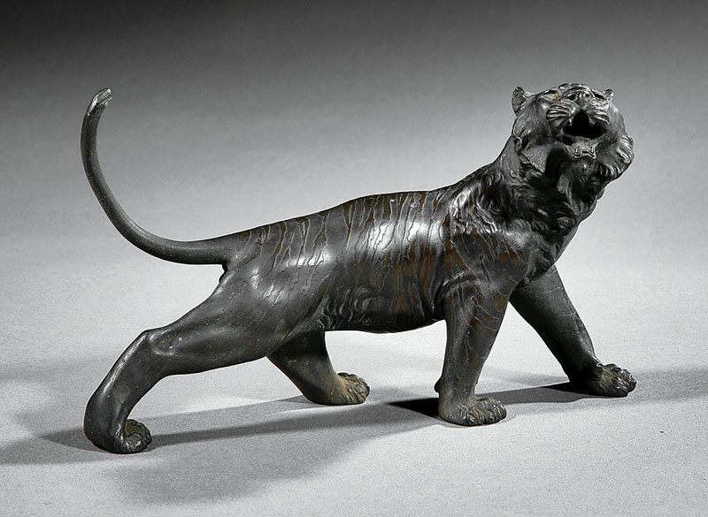 Japanese Bronze Figure of a Tiger: A Japanese Bronze Figure of a Tiger, late 19th/early 20th c., modeled striding with its tail and roaring head held high, signed, height 6 1/4 in., width 11 3/8 in