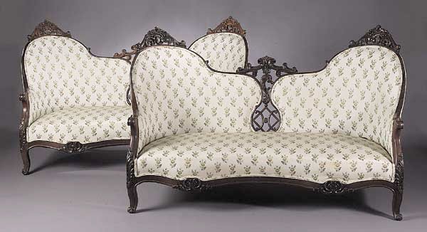 A Fine Pair of American Rococo Carved: A Fine Pair of American Rococo Carved Rosewood Settees , mid-19th c., each having a pierced serpentine back with floral and scroll crests, serpentine seat rail with acanthus carved cabriole legs, heig