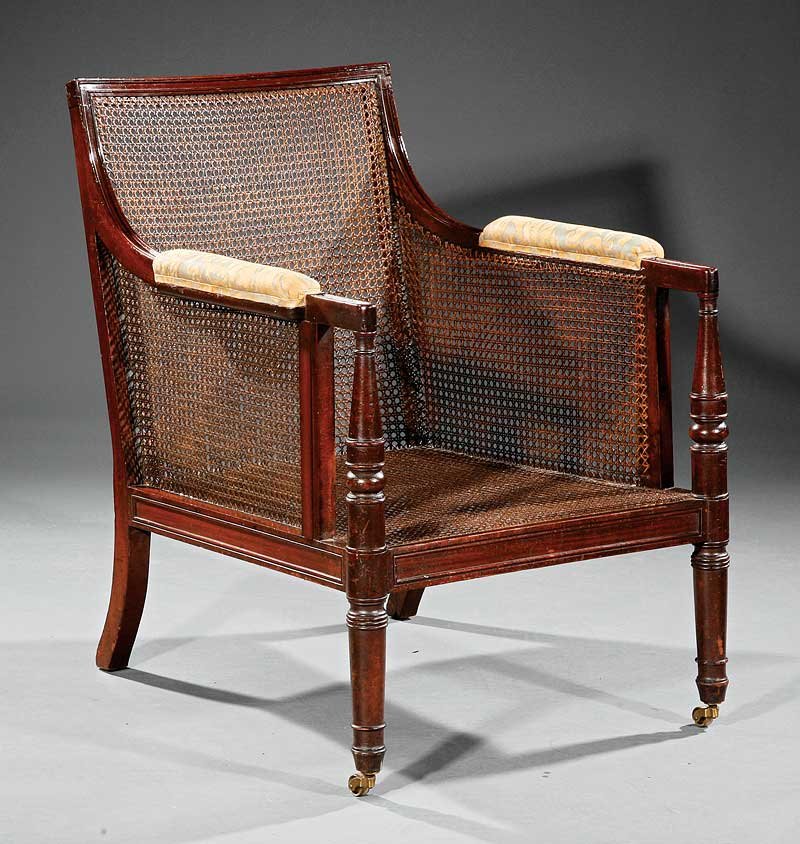 Regency Mahogany and Caned Gentleman's Library Armchair: A Regency Mahogany and Caned Gentleman's Library Armchair, early 19th c., fitted with cushions, on ring-turned legs, casters