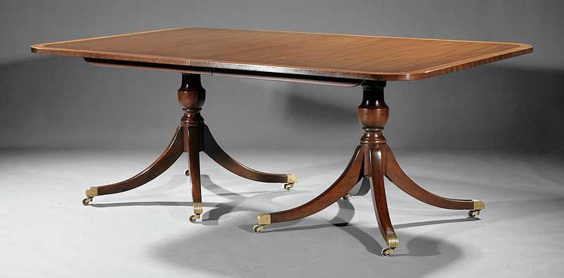 Two Pedestal Mahogany Dining Table, Kittinger: An American Regency-Style Mahogany Two Pedestal Dining Table, Kittinger, branded, satinwood banded top, vasiform supports, outswept legs, brass cuff casters, height 29 in., length 78 in., width 48 in.