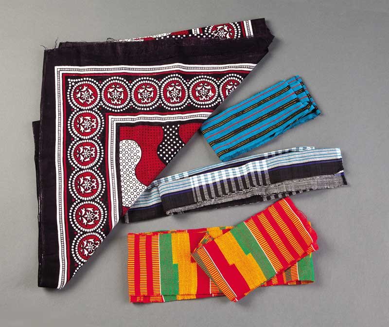 A Group of Four African Cotton Textiles: A Group of Four African Cotton Textiles, including three Kente cloth strips, Ghana, lengths 115 in., 36 in., and 63 3/4 in., and a printed scarf, Kenya, 63 in. x 41 in . Provenance: Property of the Hi