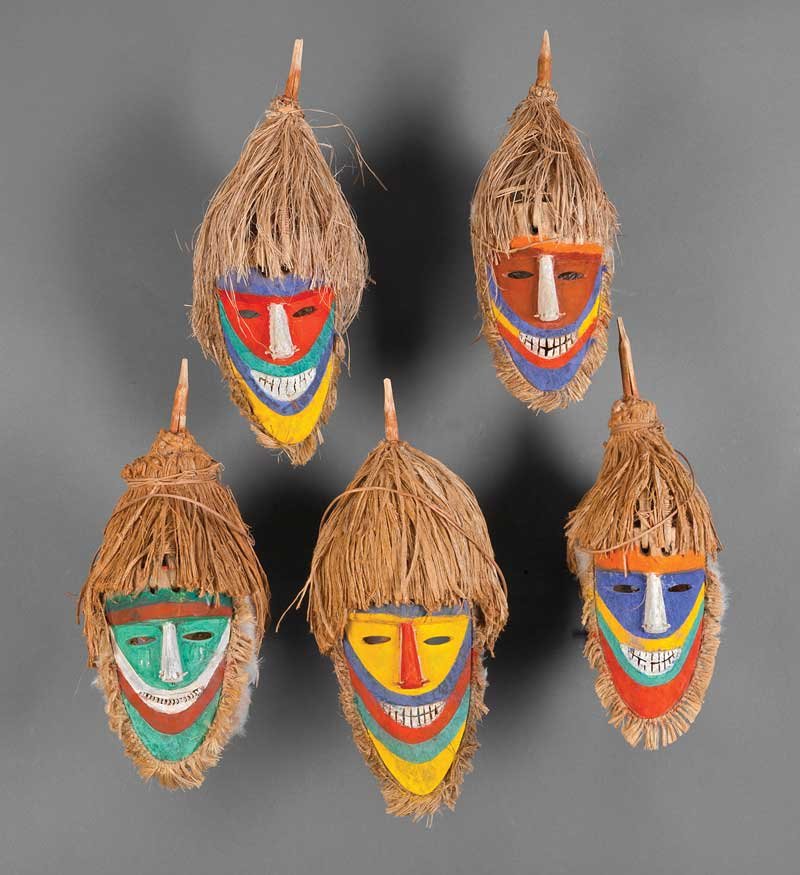 A Group of Five Tolai Polychrome Painted Carved W: A Group of Five Tolai Polychrome Painted Carved Wood Dance Masks, Gazelle Peninsula, New Britain, each of almond form with raffia and feather surround, surmounted by conical fiber headdress, overall h