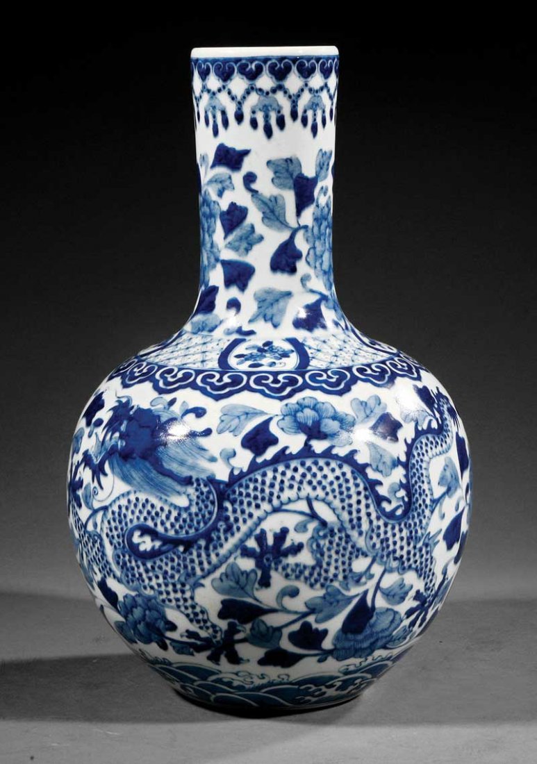 A Chinese Blue and White Porcelain Bottle Vase: A Chinese Blue and White Porcelain Bottle Vase, probably 20th c., decorated with dragons amid peonies, base with Kangxi mark, height 16 in