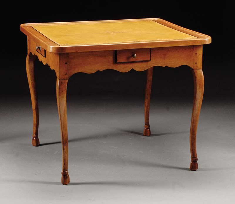 A French Provincial Fruitwood Games Table: A French Provincial Fruitwood Games Table, late 18th/early 19th c., tooled leather top, frieze with four "gaming" drawers, restrained cabriole legs, hoof feet, height 28 in., width 30 in., depth 33 in