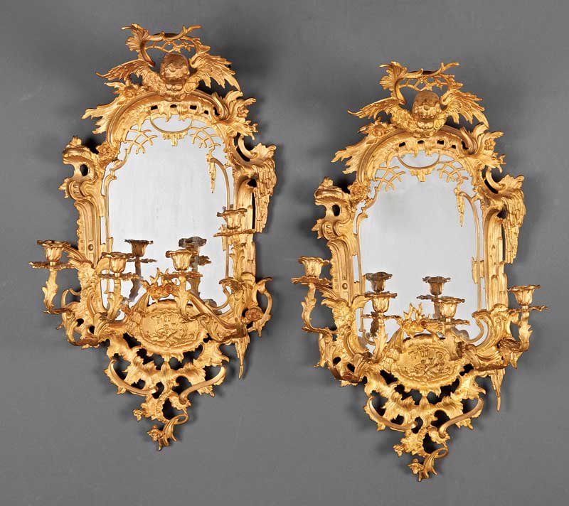 Gilt Bronze Four-Light Girandole Mirrors: A Pair of Rococo-Style Gilt Bronze Four-Light Girandole Mirrors, 19th c., each with eagle crest, foliate scrolled surround, candlearms flanking a medallion, height 24 3/4 in., width 14 in., depth 7 3/