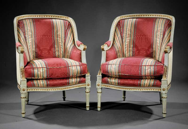 Carved, Painted and Parcel Gilt Bergeres: A Pair of Louis XVI-Style Carved, Painted and Parcel Gilt Bergeres, arched molded crest rail, padded back, acanthine arms, serpentine seat rail, tapering fluted legs surmounted by rosette carved block