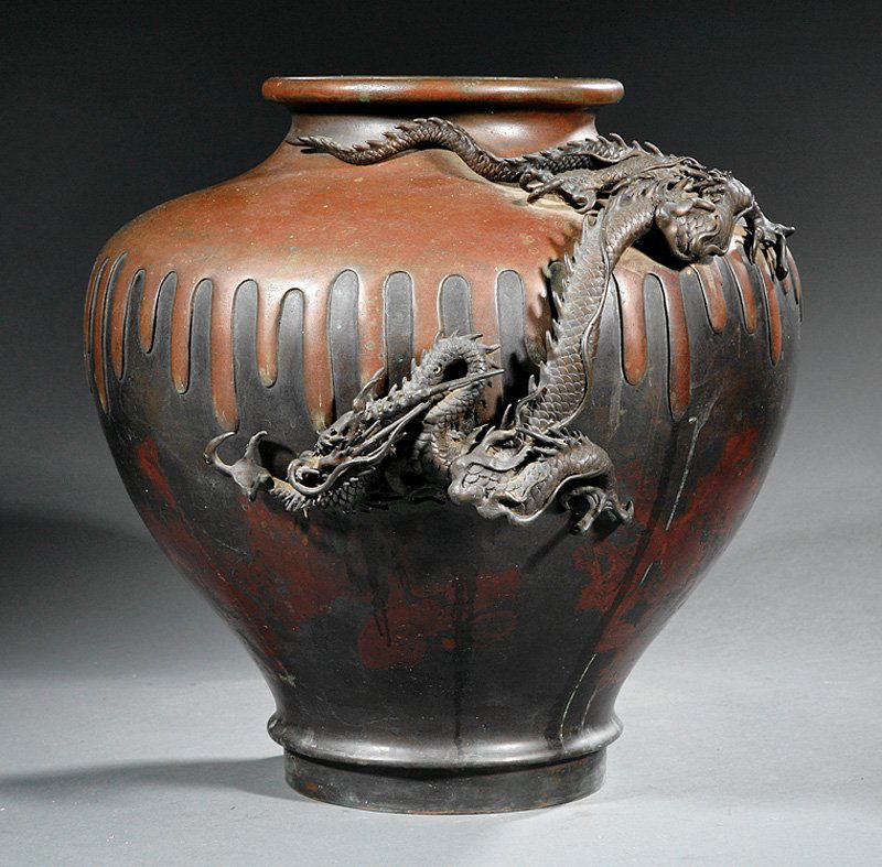 A Japanese Bronze Urn: A Japanese Bronze Urn, probably Meiji Period (1868-1912), baluster body relief molded with a large dragon on the shoulder, modeled in imitation of pottery with dripping and pooling glaze, base inscrib