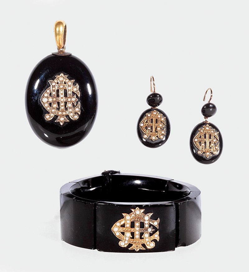 Yellow Gold, Onyx and Half Pearl Mourning Jewelry: A Suite of English Victorian Yellow Gold, Onyx and Half Pearl Mourning Jewelry, including a bangle bracelet, open back locket and pair of drop earrings, all with entwined monogram