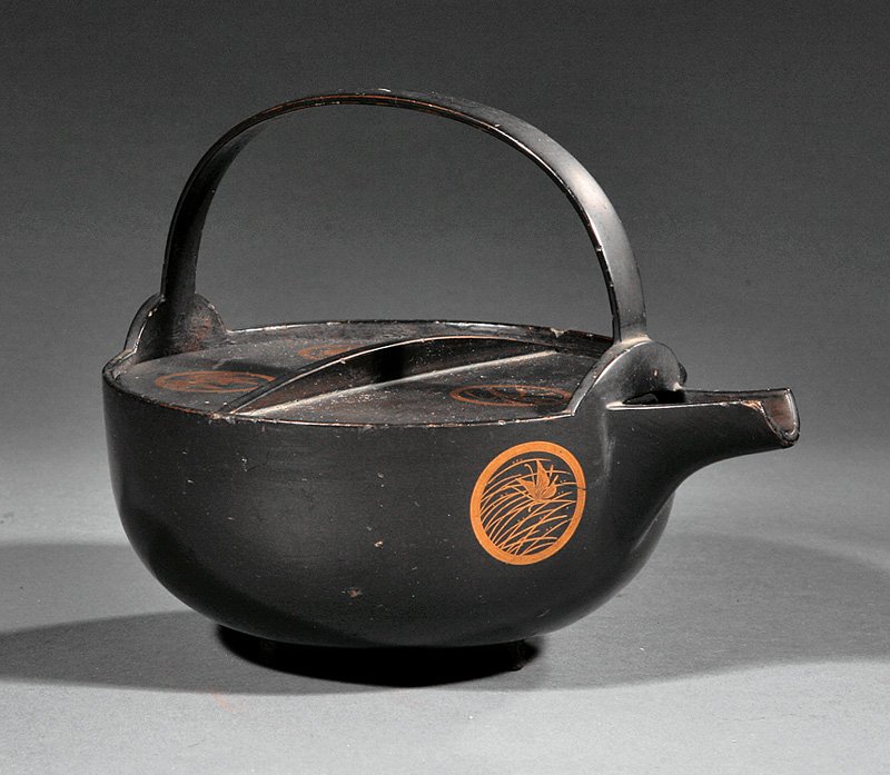 Japanese Gilt Decorated Lacquered Iron Kettle: A Japanese Gilt Decorated Black Lacquered Iron Kettle, probably Meiji Period (1868-1912), U-form body with arched spout, loop handle and flat cover, decorated with floral and grass roundels, height 6 