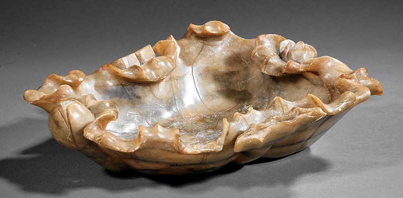 A Chinese Soapstone Lotus Dish: A Chinese Soapstone Lotus Dish, probably 20th c., mottled brown stone carved as a furled lotus leaf with buds and seed pods, height 3 7/8 in., width 13 1/4 in., depth 11 1/4 in