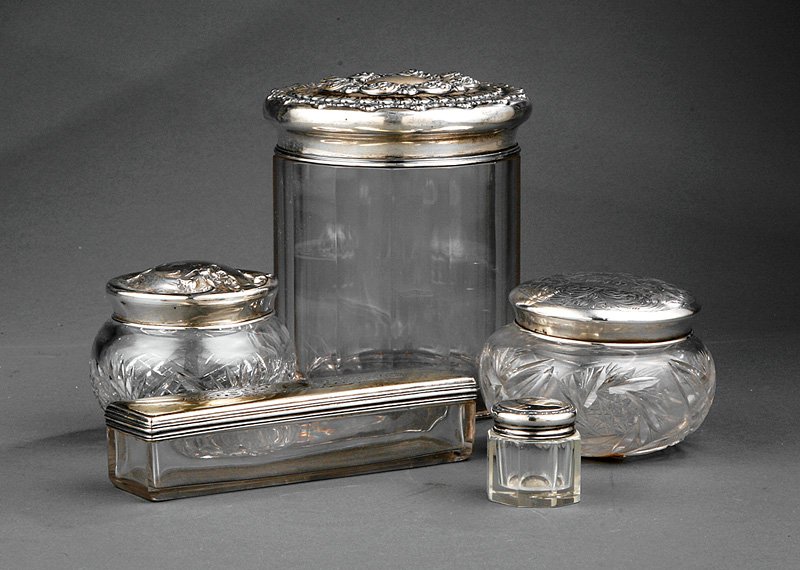 Five Sterling Silver and Glass Vanity Jars: Five English and American Sterling Silver and Glass Vanity Jars, including a toothbrush case, Archibald Douglas, London, 1834, length 6 3/4 in., retaining some gilt surface; a large scroll repoussé j