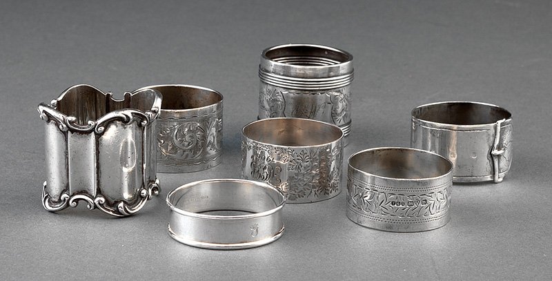 Sterling Silver Napkin Rings: A Group of English and American Sterling Silver Napkin Rings, including one belt form, William Gough, Birmingham, 1866; two with engraved decoration, E.J. Trevitt & Sons, Chester, 1919 and 1922; one w