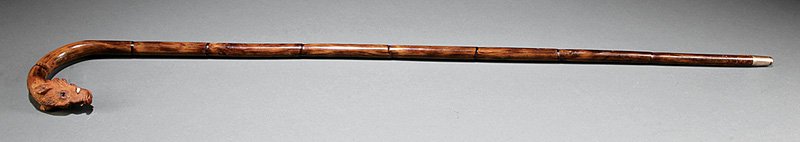A Carved Wood Boar's Head Cane: An Antique Carved Wood Boar's Head Cane, 19th c., inlaid with ivory tusks and glass eyes