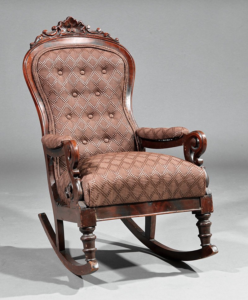 Rococo Carved Mahogany Child's Rocking Chair: An American Rococo Carved Mahogany Child's Rocking Chair, mid-19th c., molded shaped back, scrolled arms, serpentine seat, turned legs, rockers