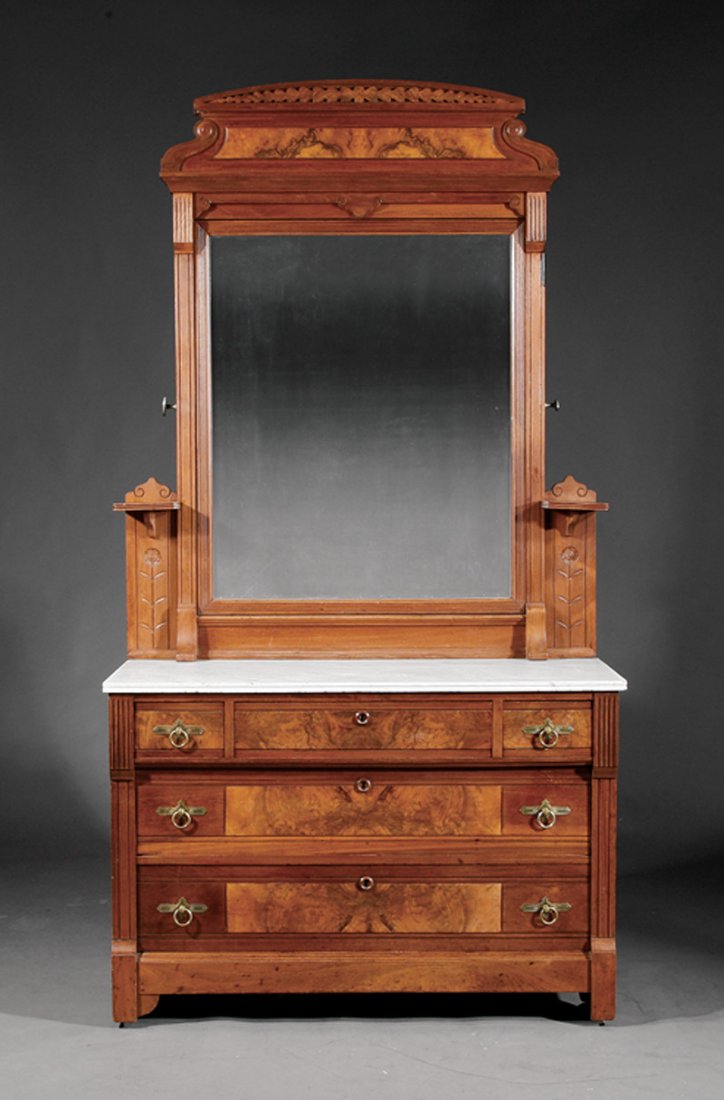 Carved and Burled Walnut Bedroom Suite: An American Renaissance Carved and Burled Walnut Bedroom Suite, c. 1870, comprising a bedstead and mirrored dresser, arched paneled headboard flanked by columns, conforming footboard, paneled rails; t