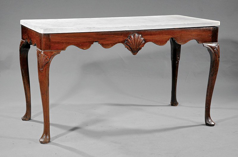 George II Carved Mahogany Slab Table: A George II Carved Mahogany Slab Table, mid-18th c., associated old marble top, scalloped frieze centering a shell, on shell-carved cabriole legs, "Drake" feet, height 31 in., width 53 in., depth 26 1