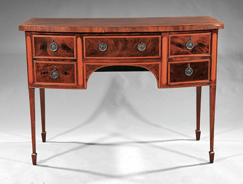 A George III Inlaid Mahogany Bowfront Sideboard: A George III Inlaid Mahogany Bowfront Sideboard, c. 1790, crossbanded top, central drawer flanked by deep drawer, small drawer and cupboard on tapered legs, spade feet, height 35 1/4 in., width 48 7/8