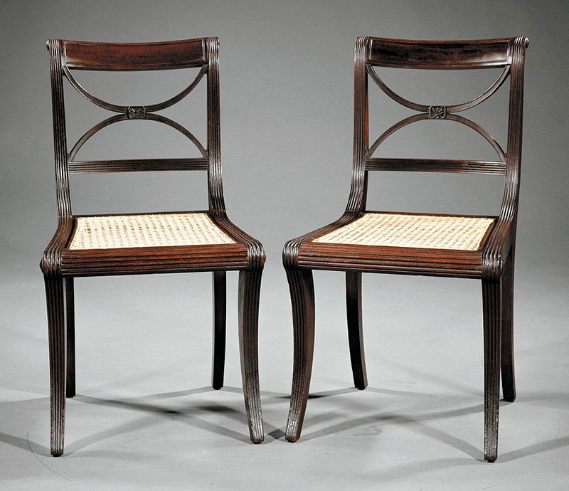 Classical Mahogany Chairs attr. Phyfe: A Pair of American Classical Mahogany Chairs, early 19th c., attributed to Duncan Phyfe, New York, each with a rectangular crest contained by reeded stiles mounted with bosses, cruciform back centered