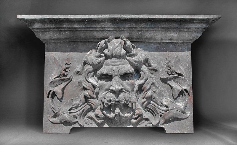 Attributed to Gustave Eiffel (French, 1832-1923): Attributed to Gustave Eiffel (French, 1832-1923), cast iron architectural panel with a colossal bas relief head of Neptune or a river god surrounded by stemmed flowers, crowned cornice, bracket feet,