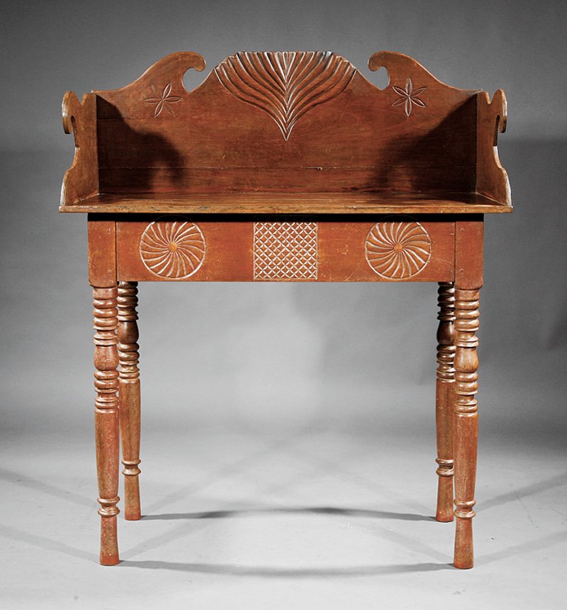 A West Indies Boldly Carved Hardwood Sideboard: A West Indies Boldly Carved Hardwood Sideboard, 19th c., palmette and compass star carved backsplash with scrolled sides, top above compass swirls and crosshatched frieze, drawer to one side, on ring-