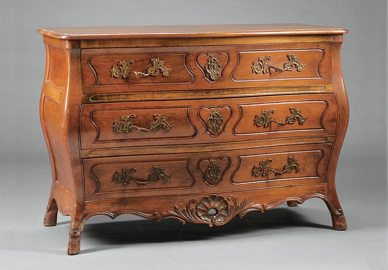 An French Provincial Carved Walnut Commod: An Antique French Provincial Carved Walnut Commode, serpentine and paneled case, three long drawers, retaining original brasses, height 35 1/2 in., width 50 in., depth 22 1/2 in