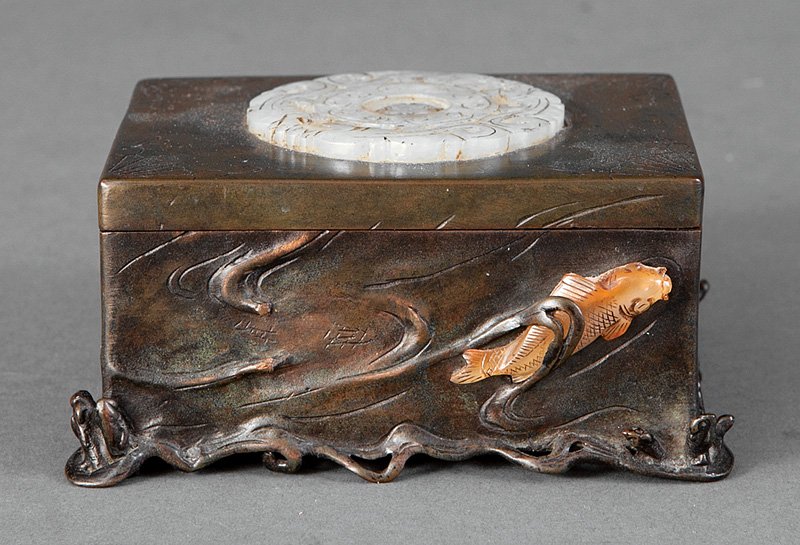 Japanese Jade, Carnelian Agate, Bronze Box: A Japanese Jade and Carnelian Agate Embellished Bronze Box, probably 1920s, rectangular body borne on crashing waves, relief modeled around the sides with waves and applied with agate fish, rectangula