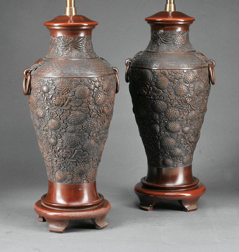 A Pair of Japanese Bronze Table Lamps: A Pair of Japanese Bronze Table Lamps, probably 20th c., ovoid bodies with sloping shoulders mounted with loose ring handles, relief modeled with chrysanthemums and foliage, height 29 in