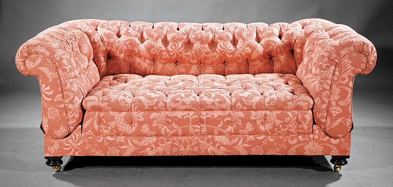 An Edwardian Tufted "Knole" Sofa: An Edwardian Tufted "Knole" Sofa, late 19th c., shaped back, double ratchet scrolled arms, turned feet, casters, height 26 in., width 70 in., depth 38 in