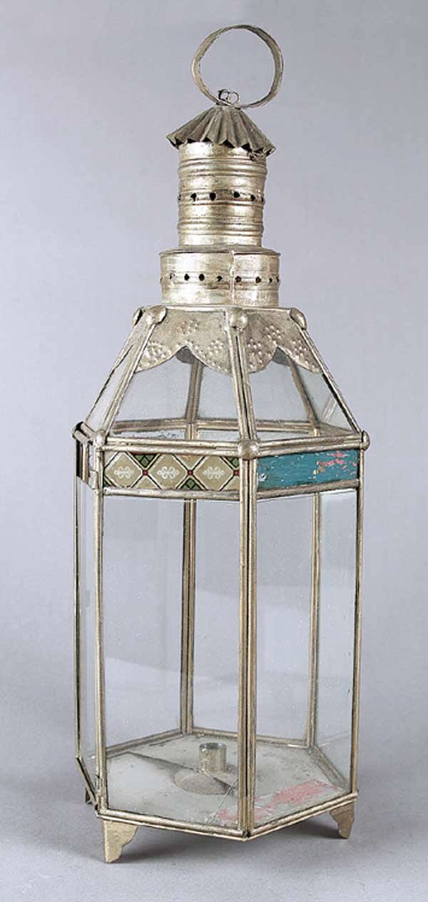 An American Tole Lantern: An American Tole Lantern , late 19th c., the glazed hexagonal form cresting in a pierced crwon surmounted by a carrying handle, height 28 in