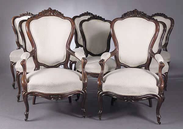 A Set of Eight French Mahogany Chaises: A Set of Eight French Mahogany Chaises in the Louis XV Taste , c. 1855, including a pair of fauteuils, each cartouche form back rest cresting in leaves, the serpentine seat frame raised on cabriole le
