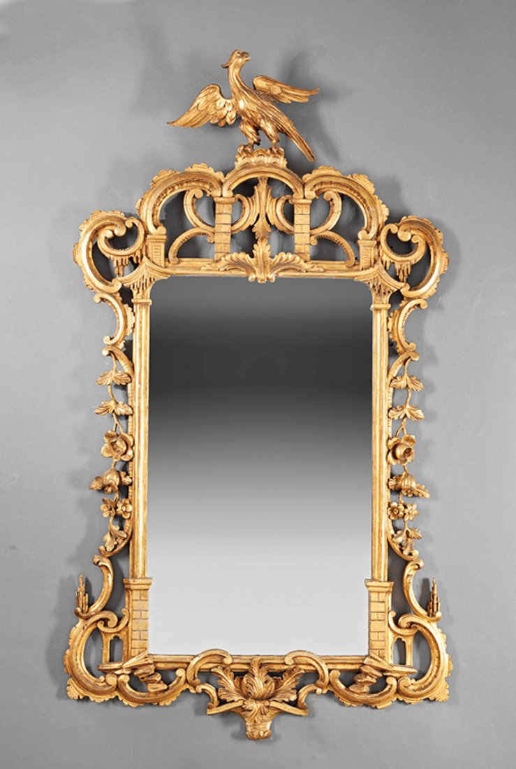 A Pair of Antique Chippendale-Style Giltwood Mirrors: A Pair of Antique Chippendale-Style Giltwood Mirrors, each reticulated crest surmounted by ho-ho bird, height 54 in., width 31 in. Provenance: Estate of Aloyis Lee Sonneborn, Mobile, AL