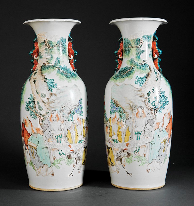 A Pair of Chinese Famille Rose Porcelain Vases: A Pair of Chinese Famille Rose Porcelain Vases, probably 20th c., tapering bodies with waisted flared necks and foliate rims with pairs of confronting Buddhist lion handles, decorated with figures in 