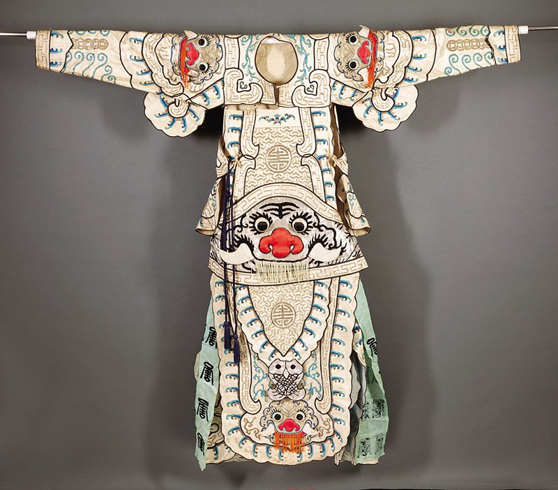 A Chinese Embroidered Opera Warrior's Robe: A Chinese Embroidered "Peking" Opera Warrior's Robe, probably early 20th c., worked in couched metallic threads and satin stitch with geometric patterns, dragons and bats; the waist, shoulders and foo