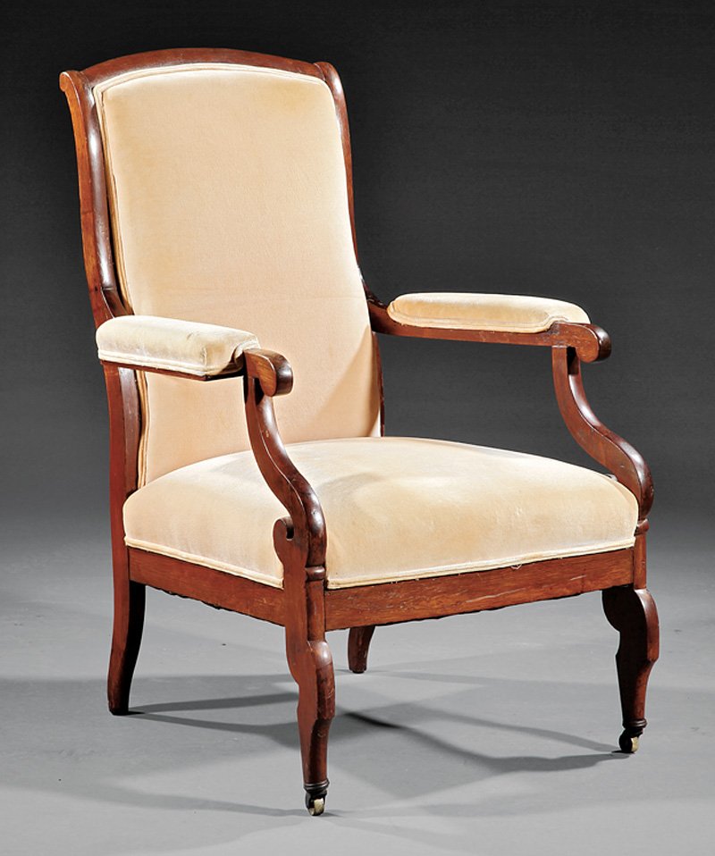 Carved Rosewood "Voltaire" Armchair: An American Classical Carved Rosewood "Voltaire" Armchair, mid-19th c., New York, school of Duncan Phyfe, arched crest with padded arms, S-scroll supports, straight seat rail, saber legs, casters