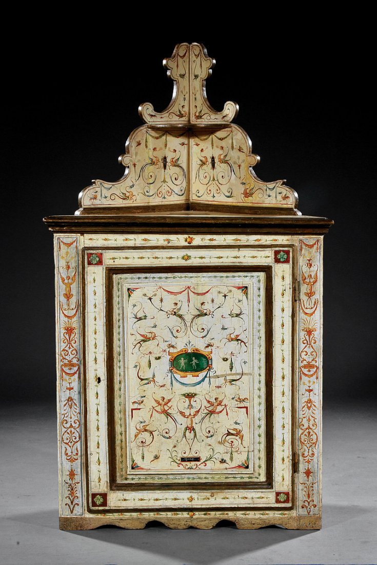 Neoclassical Paint-Decorated Encoignure: An Italian Neoclassical Paint-Decorated Encoignure, scrolling superstructure with shelf, paneled cabinet door, polychrome grotesques on cream ground, bracket feet, height 61 in., width 35 in., depth 1