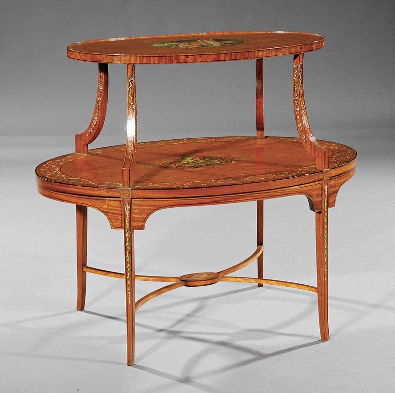 An Edwardian Paint-Decorated Satinwood Desserte: An Edwardian Paint-Decorated Satinwood Desserte, early 20th c., molded oval top, shaped supports, conforming second tier, square tapered legs, height 31 1/2 in., width 35 in., depth 22 in