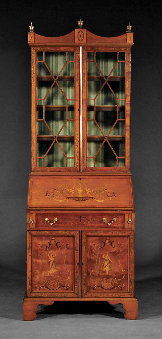 An Edwardian Satinwood Inlaid Bureau Bookcase: An Edwardian Satinwood Inlaid Bureau Bookcase, early 20th c., shaped pediment with urn-form finials above glazed doors with foliate and penwork inlays, slant-front lid inlaid with figures flanking an 