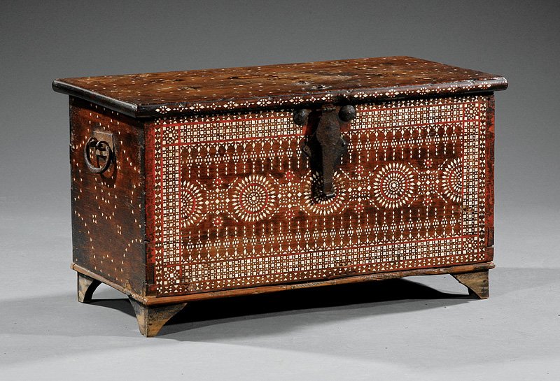 Mother-of-Pearl Inlaid Hardwood Trading Chest: An Indonesian Mother-of-Pearl Inlaid Hardwood Trading Chest, probably 19th c., rectangular body raised on four triangular feet, overhanging hinged lid, iron strap handles and lock, front face with ext