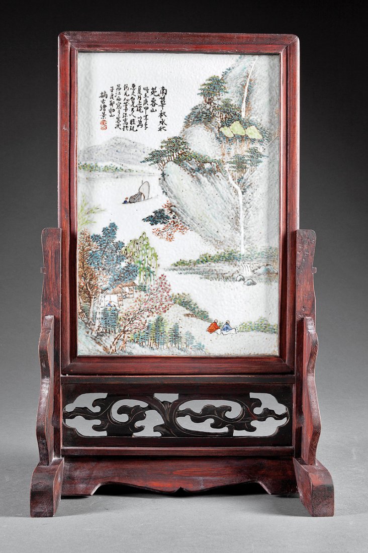 A Chinese Famille Rose Porcelain Table Screen: A Chinese Famille Rose Porcelain Table Screen, probably 20th c., rectangular panel painted with a figural waterscape, sight 14 1/2 in. x 9 3/4 in., framed and mounted in a carved wood stand, overall h