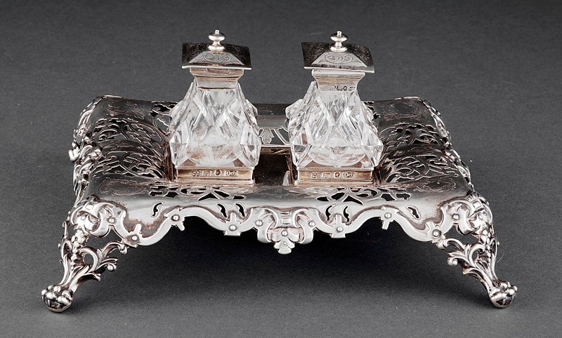 Henry Wilkinson & Co Sterling Silver Standish: An Early Victorian Sterling Silver Standish, Henry Wilkinson & Co., Sheffield, 1847, oblong form raised on paw supports; fitted with two silver mounted glass inkpots, engraved crest armorial, height 4