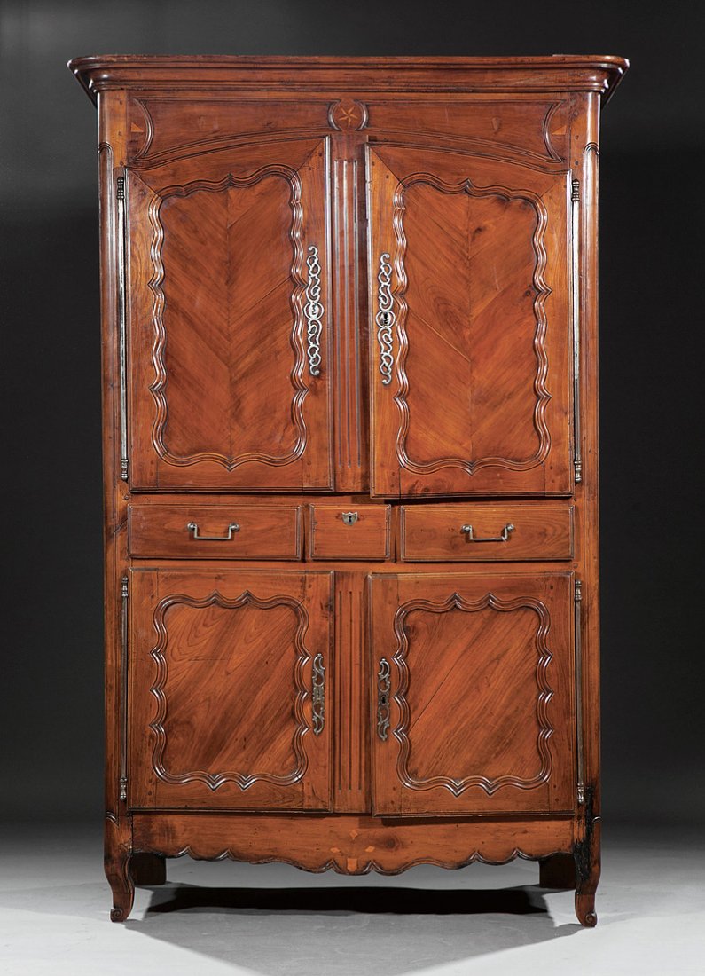 Carved and Inlaid Fruitwood Buffet à Deux Corps: A French Provincial Carved and Inlaid Fruitwood Buffet à Deux Corps, 18th c., cove molded cornice, paneled inlaid frieze above two arched scalloped doors, shelf interior, three medial drawers, confor