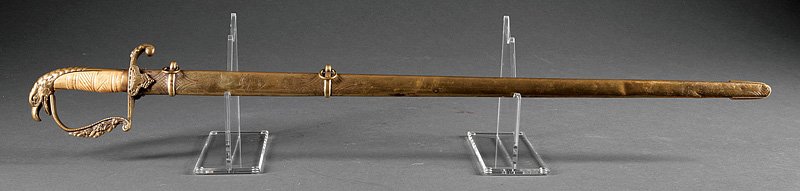 An American Military Eagle Head Sword: An American Military Eagle Head Sword, 19th c., eagle head pommel, claw quillon, carved bone grip, blade etched with foliate designs, spread-eagle and Liberty cap, brass scabbard, blade length 30 1/2