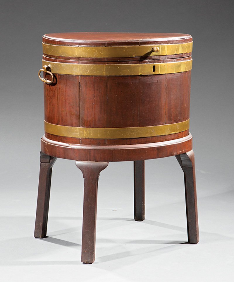 Georgian Brass-Mounted Mahogany Cellarette: Georgian Brass-Mounted Mahogany Cellarette, late 18th c., banded oval body, hinged lid, fitted interior, ring handles, h. 14 3/8 in., w. 22 in., later stand, overall h. 28 1/2 in. Provenance: Wrightsv