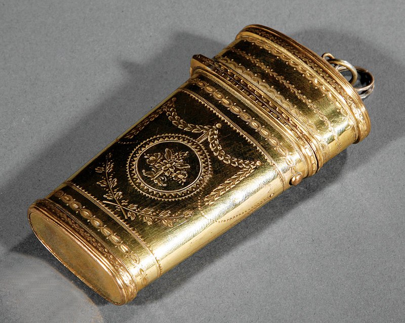 French Neoclassical Gilt Brass Etui: French Neoclassical Gilt Brass Etui, c. 1800, tapered body, hinged lid, fitted compartments with needle and brush, floral bouquet and swag reserves, guilloche borders, h. 3 5/8 in., w. 2 7/8 in