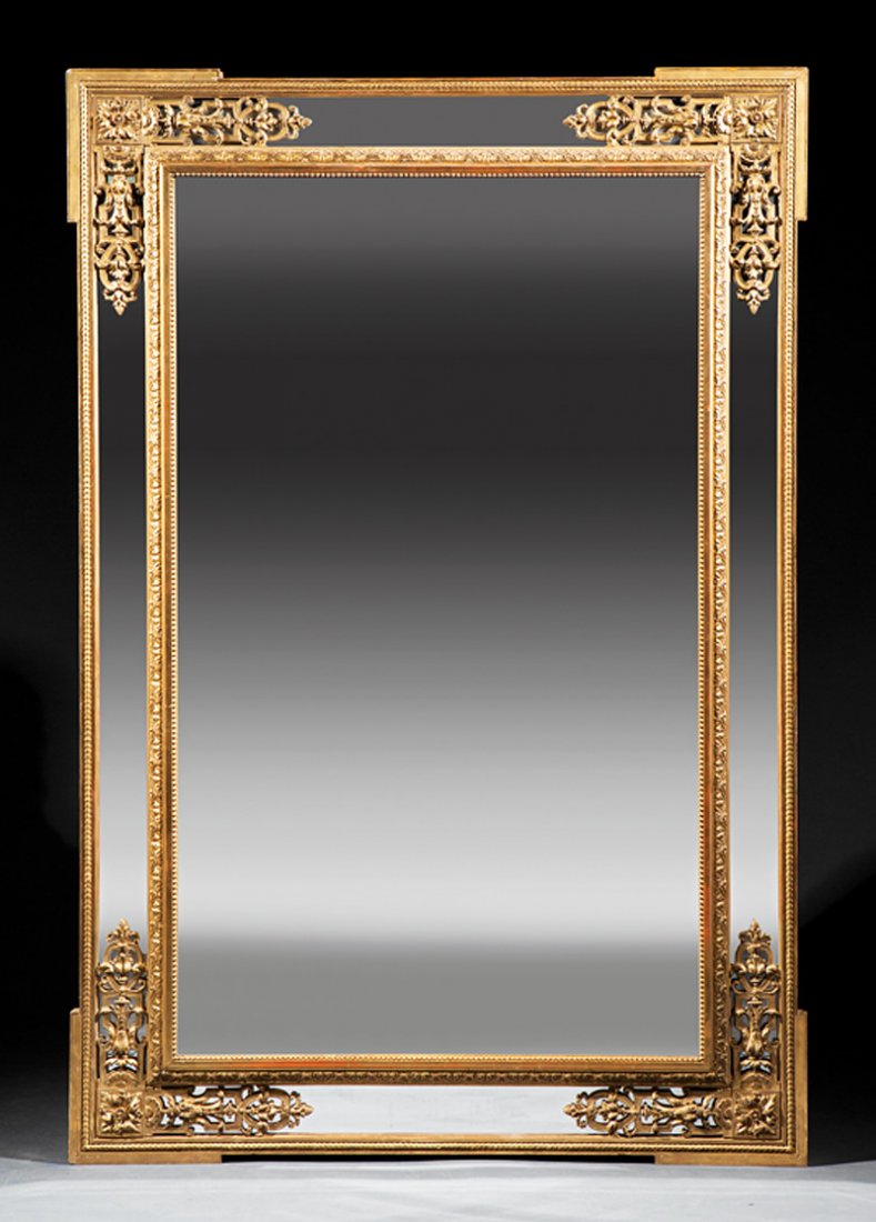 Antique Louis XVI-Style Carved Giltwood Mirror: Antique Louis XVI-Style Carved Giltwood Mirror, late 19th c., reticulated foliate and rosette corners, mirrored surround, beaded inner frame, beveled mirror plate, retains original gilt, h. 72 5/8 in.